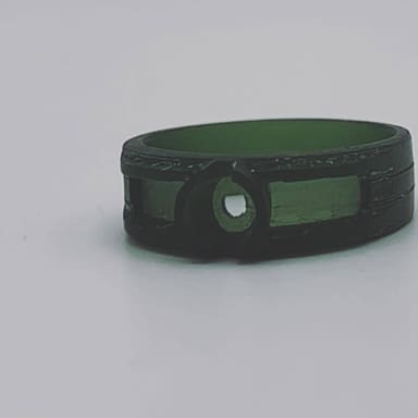 A ring pattern carved by hand out of green jeweller's wax.